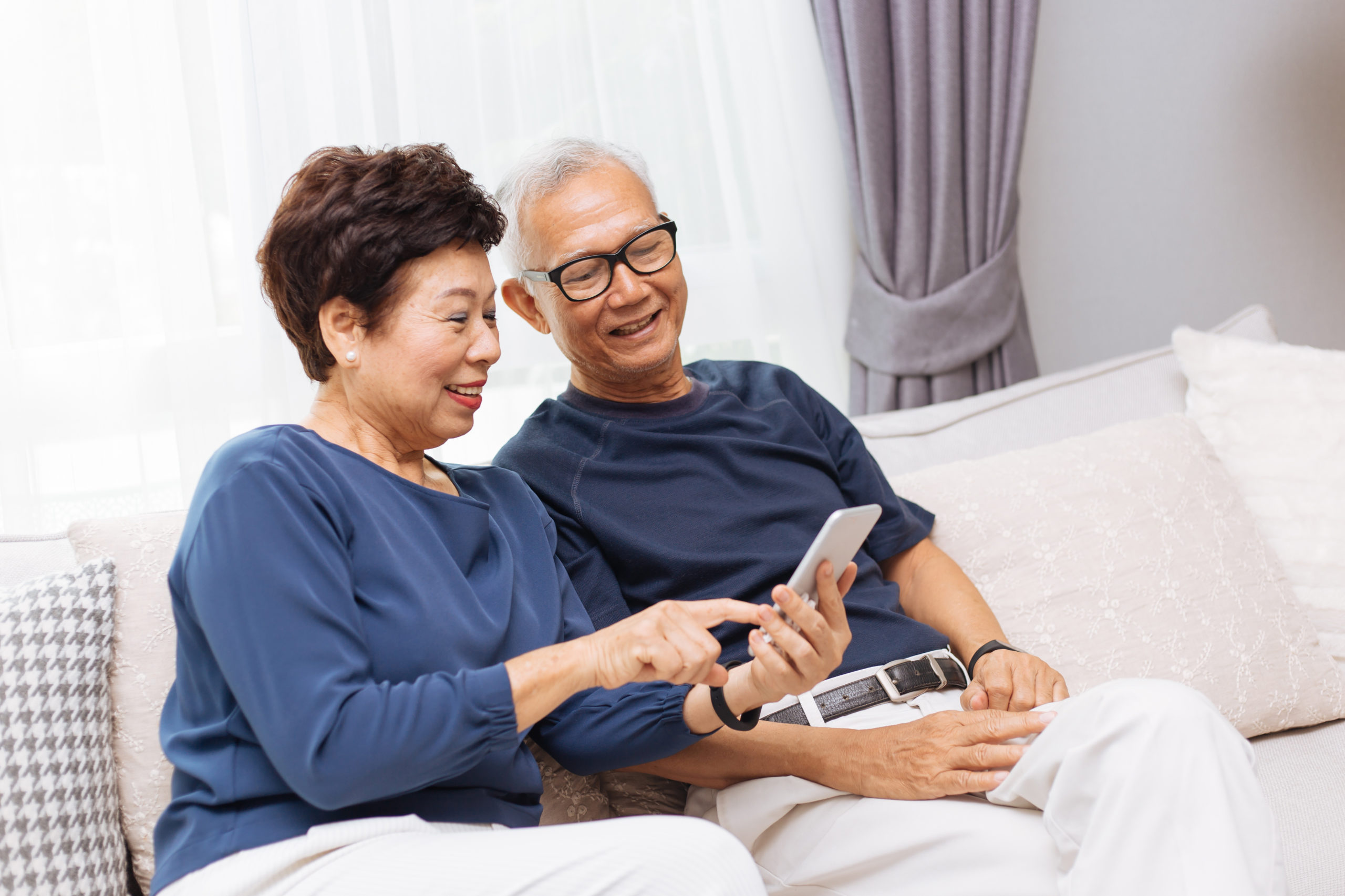 providers using modern patient financial engagement tactic to help asian senior couple pay medical bill on phone