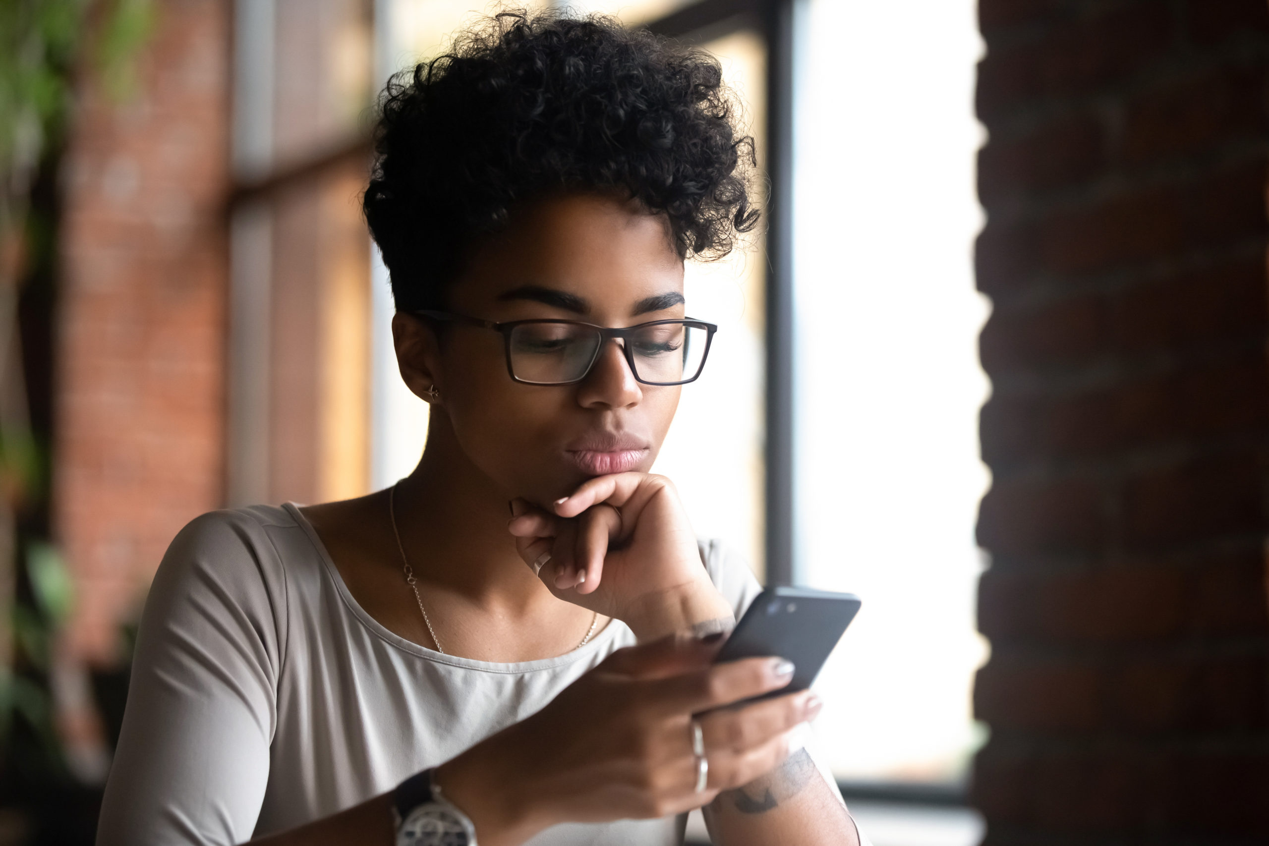 serious woman surfing internet on phone