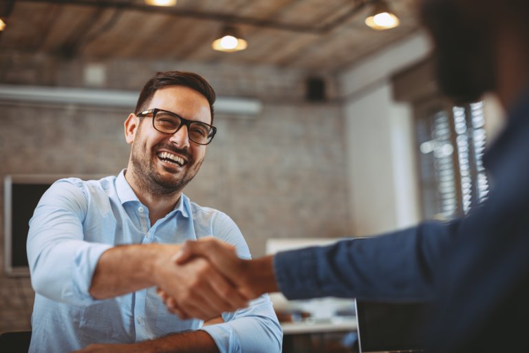 healthcare leader shaking hands with carepayment team member who has epic expertise