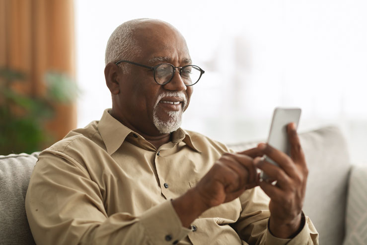man using advanced patient engagement feature text to pay to pay medical bills sitting at home