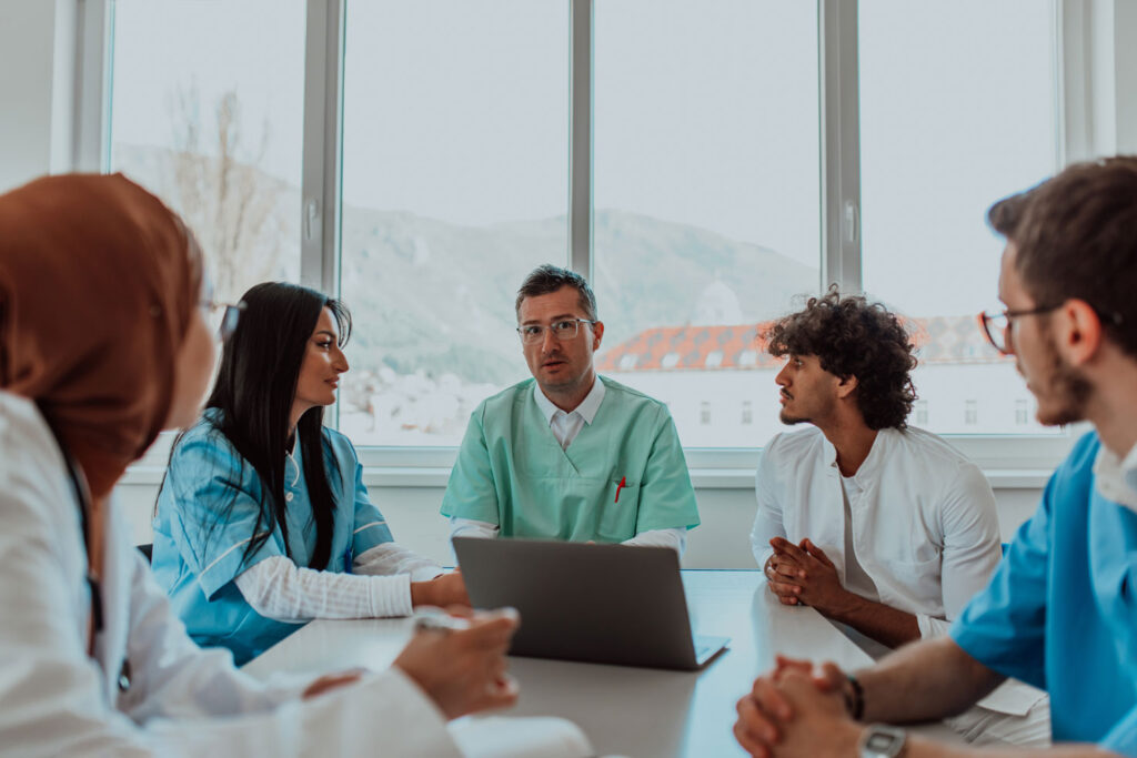 hospital provider meeting about patient financial responsibility with glass windows