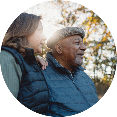 circular image of happy and healthy couple taking a walk in autumn at sunset